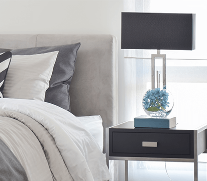 Bed with nightstand and lamp