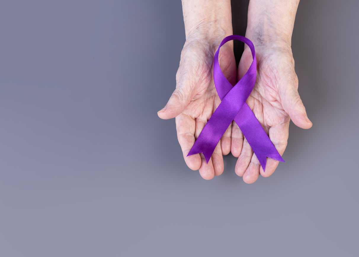 hands with purple ribbon