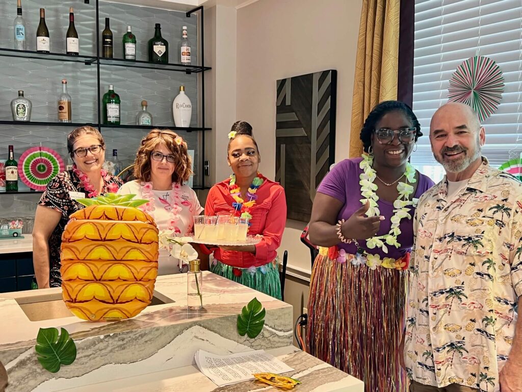 Friends enjoying the luau themed party at a senior living community.