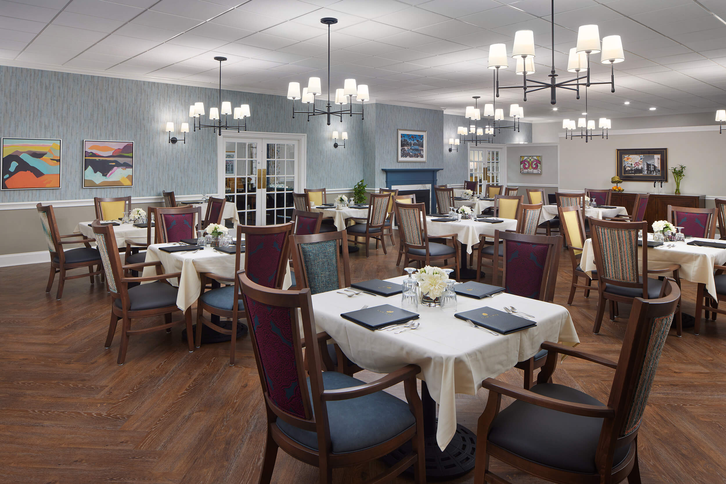 Elegant dining room with neatly arranged tables and chairs, ready for a meal service.