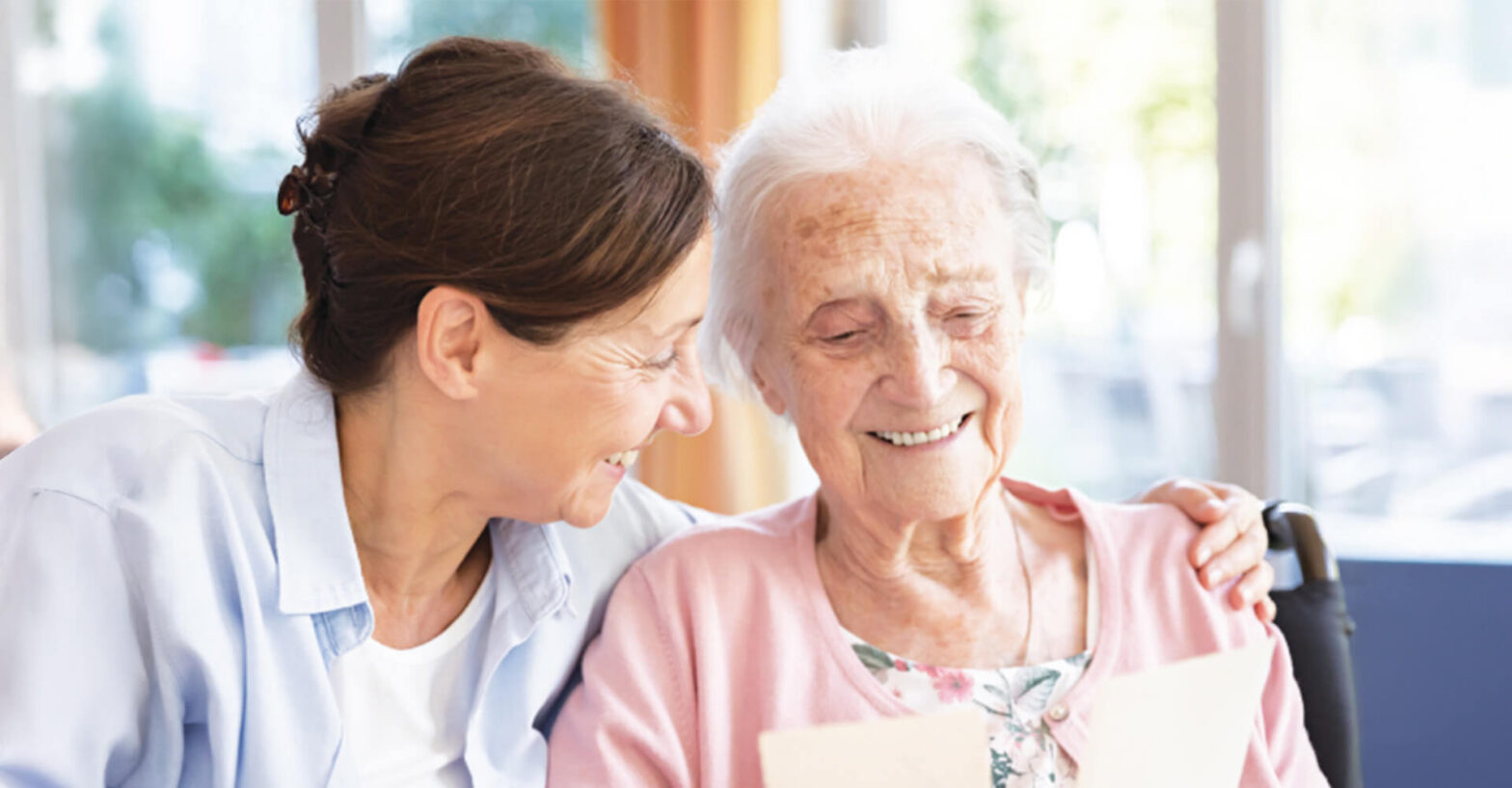 Senior woman and adult daughter share a hug