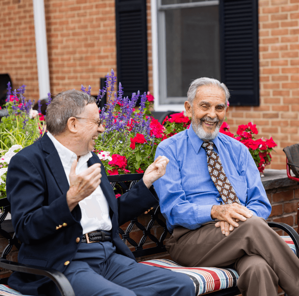 Residents enjoy a cheerful moment among vibrant flowers at the community garden.