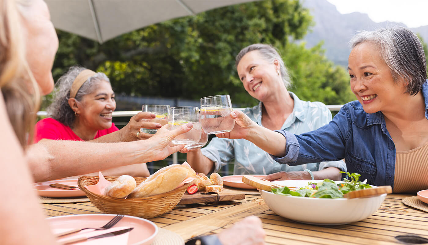 Female friends toast over dinner outdoors